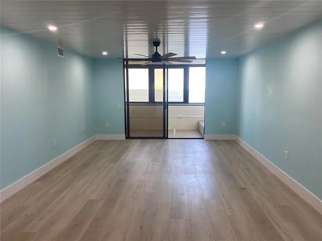 a bedroom with a large bed and a large window