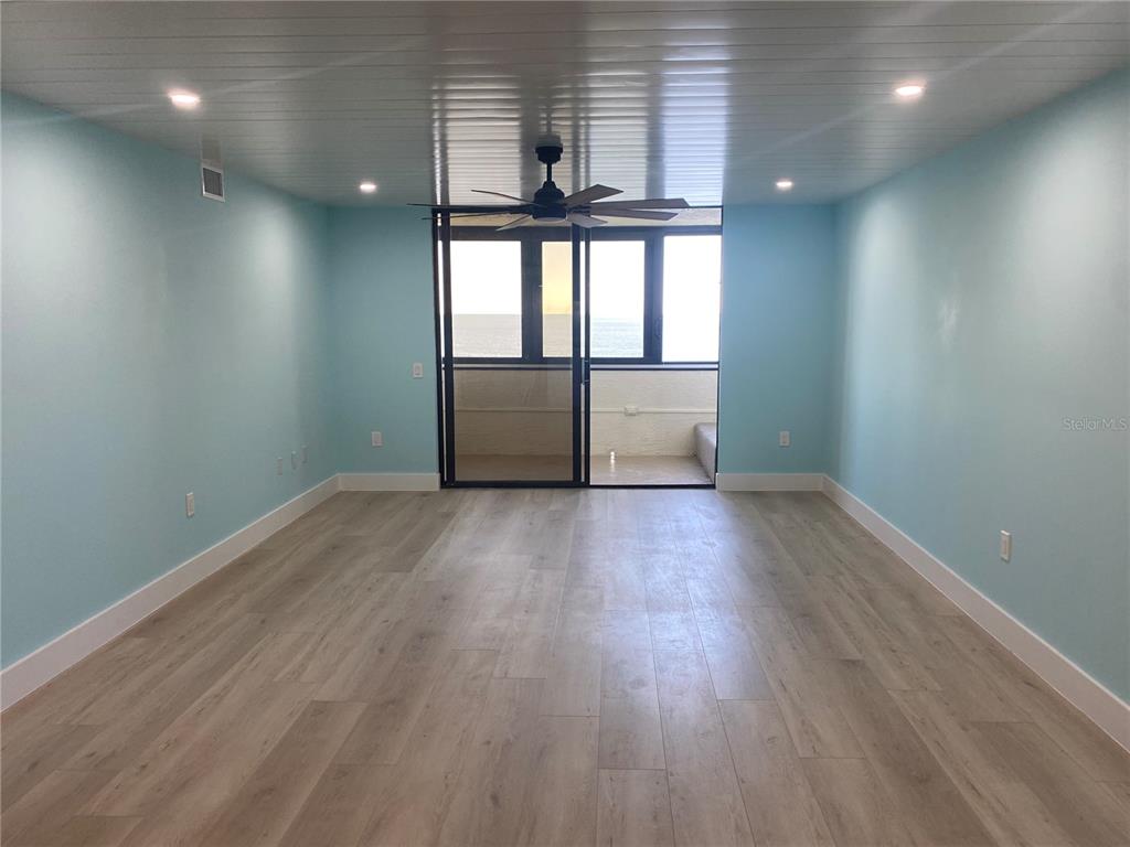 6035 Sea Ranch Drive, Unit 902 Hudson, FL 34667 - Photo 8 of 32 an empty room with wooden floor and windows