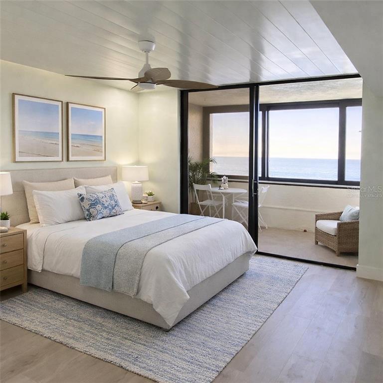 6035 Sea Ranch Drive, Unit 902 Hudson, FL 34667 - Photo 9 of 32 a bedroom with a large bed and a large window