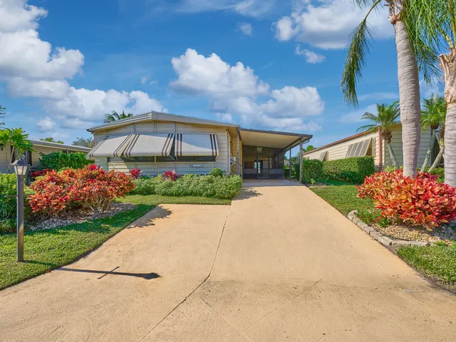a front view of house with a garden