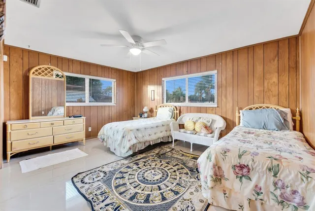 a bedroom with a bed and ceiling fan