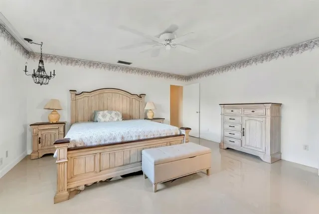 a bedroom with a bed and a chandelier