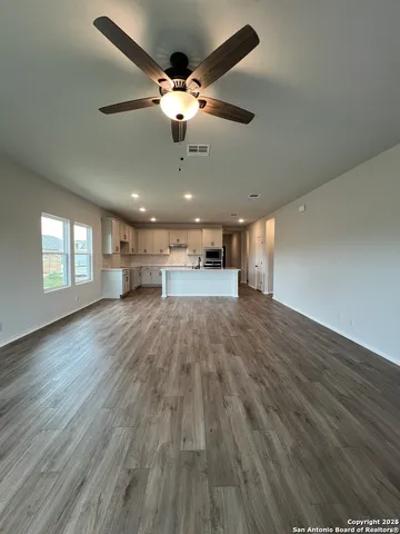 a spacious bathroom with 2 sink and a mirror