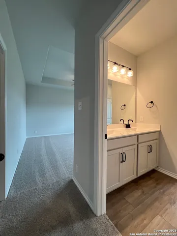 an empty room with a window and a ceiling fan