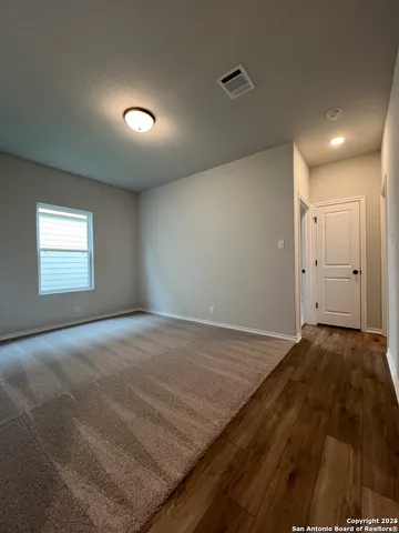 a view of an empty room and a bathroom