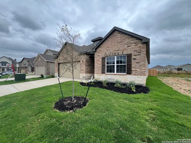 a view of a house with a yard and porch