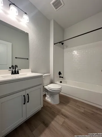 a bathroom with a sink a toilet and a bathtub