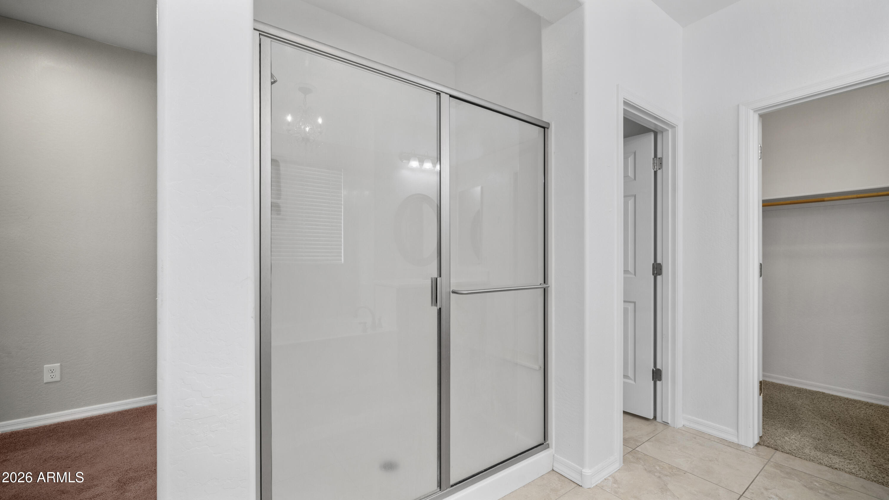16159 West Granada Road Goodyear, AZ 85395 - Photo 26 of 41 a bathroom with a shower and a glass door