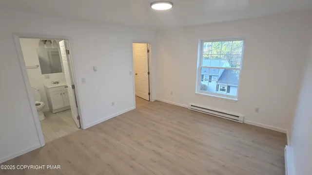 an empty room with windows and closet