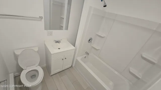 a bathroom with a sink a toilet and a bathtub