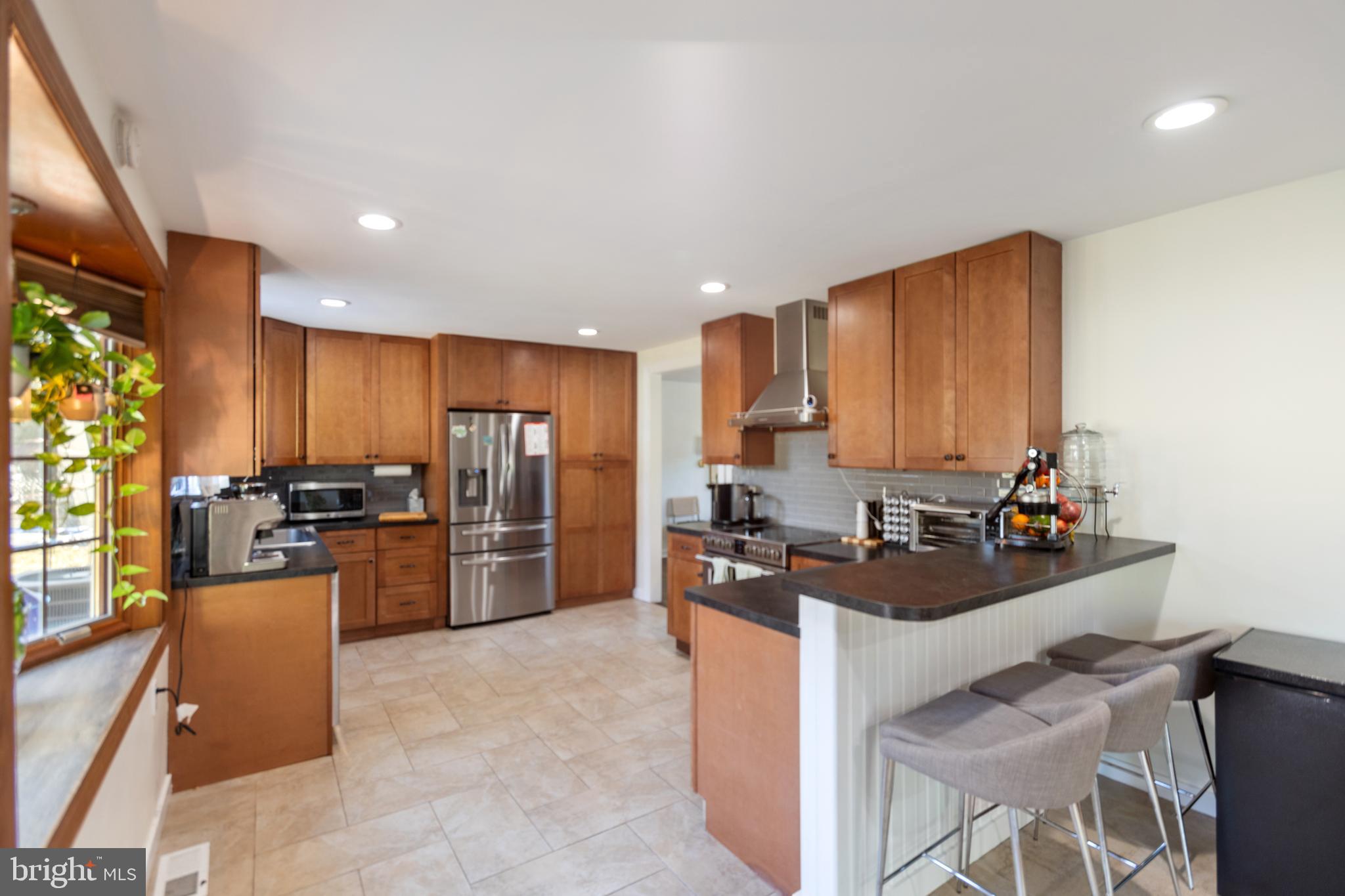 1801 North Hills Avenue Willow Grove, PA 19090 - Photo 12 of 20 a kitchen with a refrigerator and a stove top oven