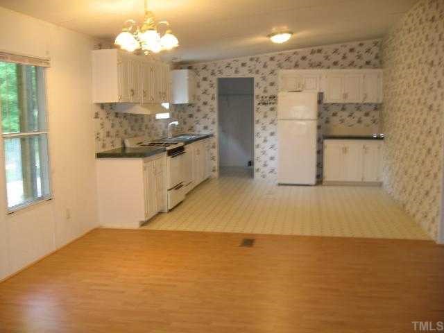 512 Fox Ridge Road Louisburg, NC 27549 - Photo 3 of 11 Large Dining room off open kitchen w/new Laminate flooring.