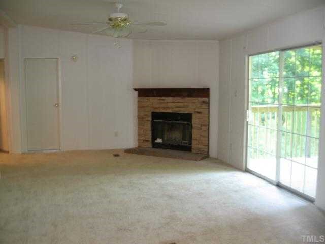 512 Fox Ridge Road Louisburg, NC 27549 - Photo 4 of 11 Wonderful cozy family room w/fireplace and sliding glass doors that lead to a party deck 11x42 WOW!