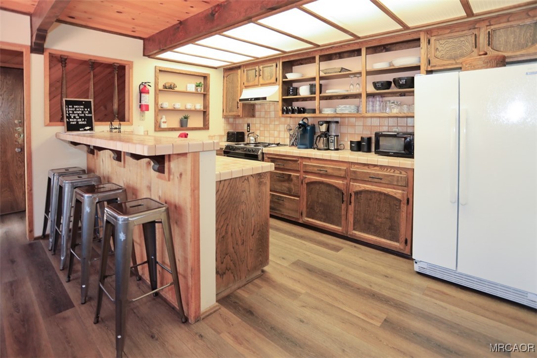 1201 Fox Farm Road Big Bear City, CA 92315 - Photo 3 of 16 a kitchen with stainless steel appliances a refrigerator and a stove