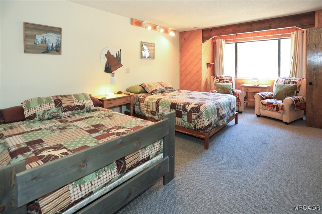 1201 Fox Farm Road Big Bear City, CA 92315 - Photo 10 of 16 a spacious bedroom with a bed and a couch