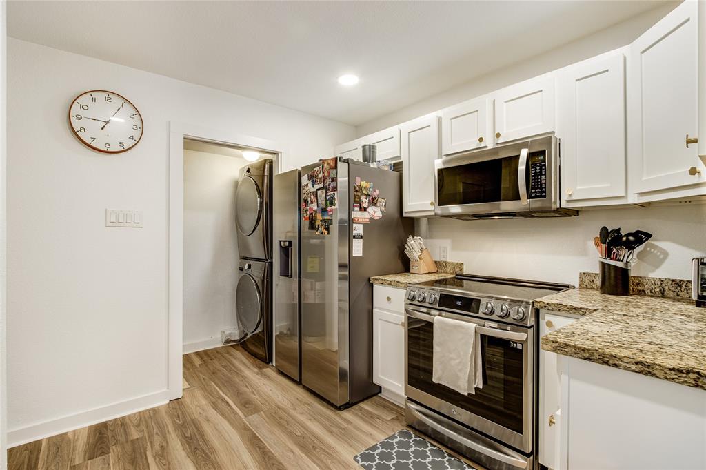 4777 Cedar Springs Road, Unit 7P Dallas, TX 75219 - Photo 13 of 28 a kitchen with stainless steel appliances granite countertop a stove a refrigerator and a microwave