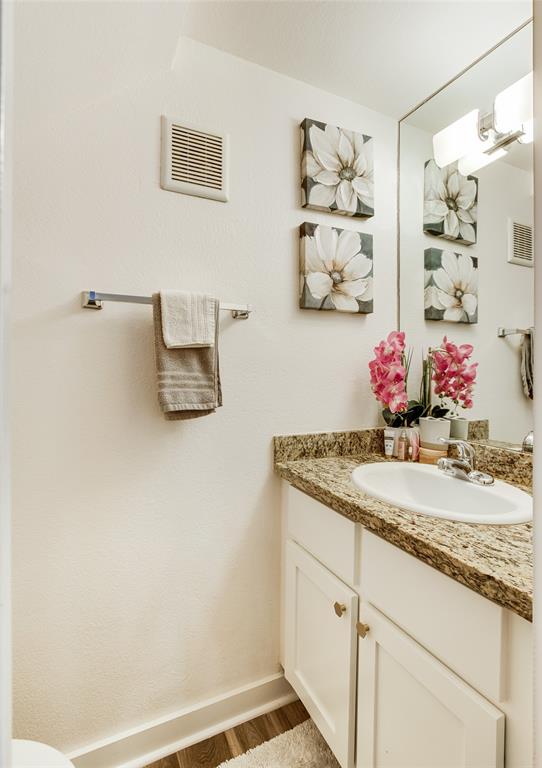 4777 Cedar Springs Road, Unit 7P Dallas, TX 75219 - Photo 15 of 28 a bathroom with a granite countertop sink a mirror and vanity