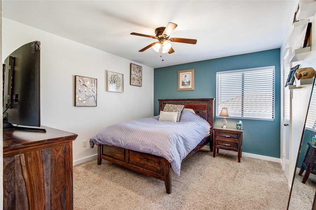 4777 Cedar Springs Road, Unit 7P Dallas, TX 75219 - Photo 19 of 28 a bedroom with a bed and a chandelier