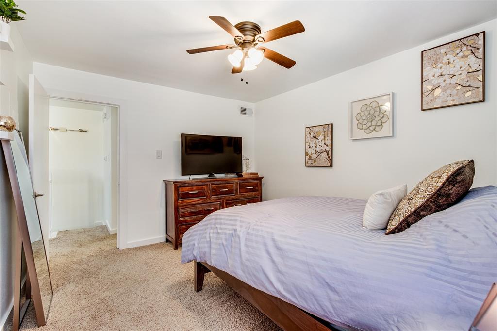 4777 Cedar Springs Road, Unit 7P Dallas, TX 75219 - Photo 20 of 28 a bedroom with a bed and a flat screen tv
