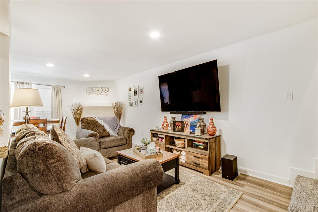 4777 Cedar Springs Road, Unit 7P Dallas, TX 75219 - Photo 9 of 28 a living room with furniture and a flat screen tv