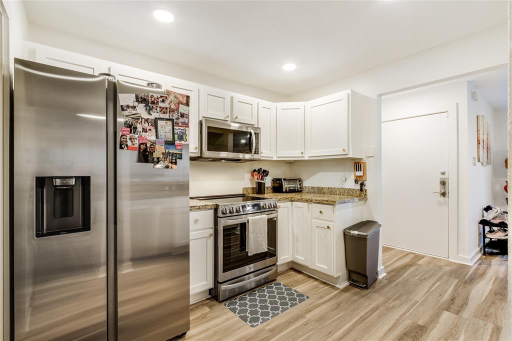 4777 Cedar Springs Road, Unit 7P Dallas, TX 75219 - Photo 10 of 28 a kitchen with stainless steel appliances granite countertop a refrigerator a stove and a sink
