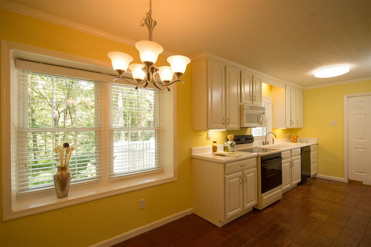 7626 Herndon Road Durham, NC 27713 - Photo 10 of 25 The sunny Kitchen and Breakfast Area have beautiful brick flooring. There is new double ceramic sink with an updated faucet. The cabinetry is beautifully crafted. Kitchen