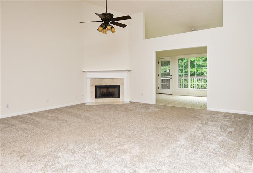 795 Sunset Ridge Lane Southeast Lawrenceville, GA 30045 - Photo 8 of 47 a view of an empty room with a fireplace and a window