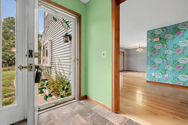 a view of an entryway with wooden floor