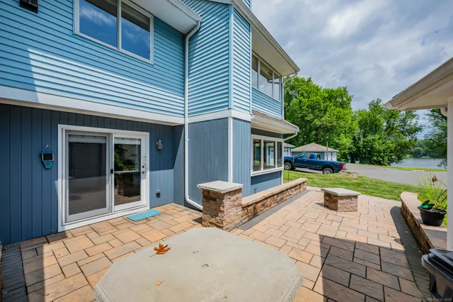 a view of a house with backyard and sitting area