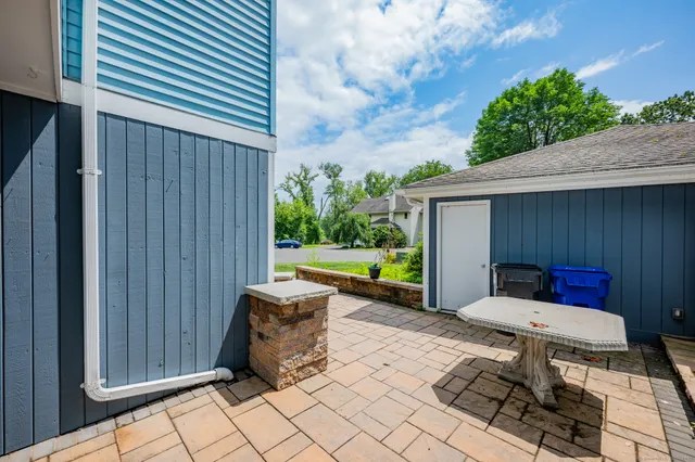 a backyard of a house with outdoor seating
