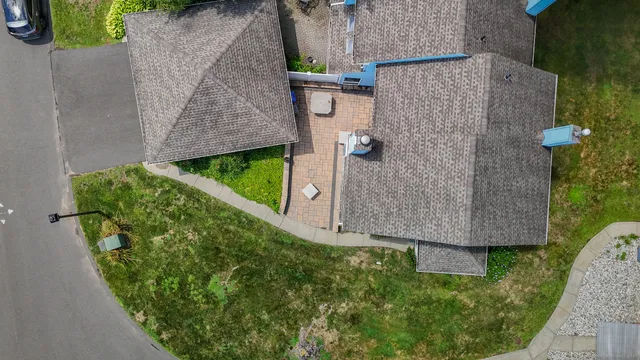 a bird view of a house with a yard and plants