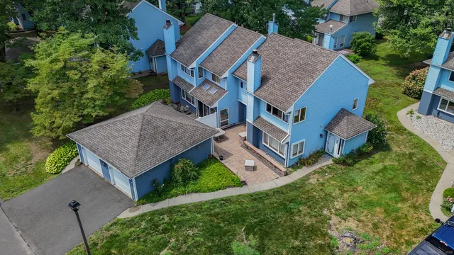 an aerial view of a house with garden space and street view