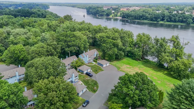 an aerial view of a house with a yard and lake view
