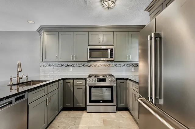 a kitchen with a sink stove and refrigerator