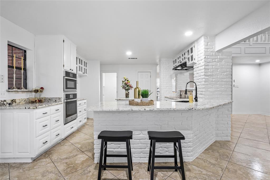 13510 Willow Springs Road Haslet, TX 76052 - Photo 12 of 39 a kitchen with granite countertop white cabinets and appliances