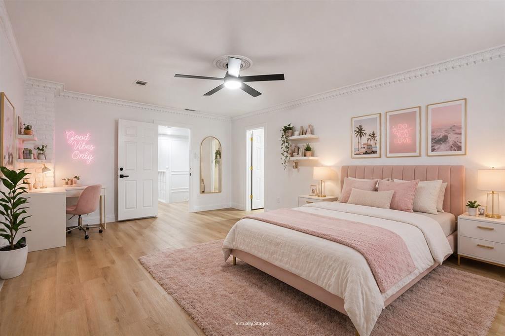13510 Willow Springs Road Haslet, TX 76052 - Photo 22 of 34 a spacious bedroom with a bed and a chandelier