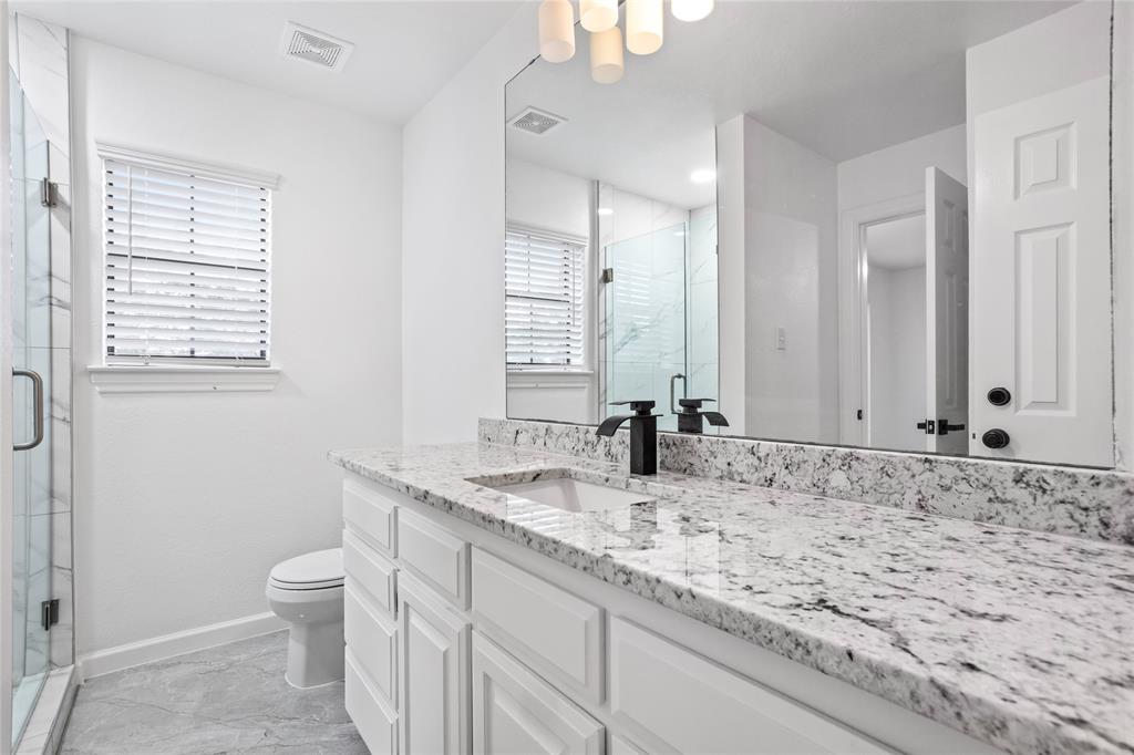13510 Willow Springs Road Haslet, TX 76052 - Photo 28 of 39 a bathroom with a granite countertop sink and a mirror