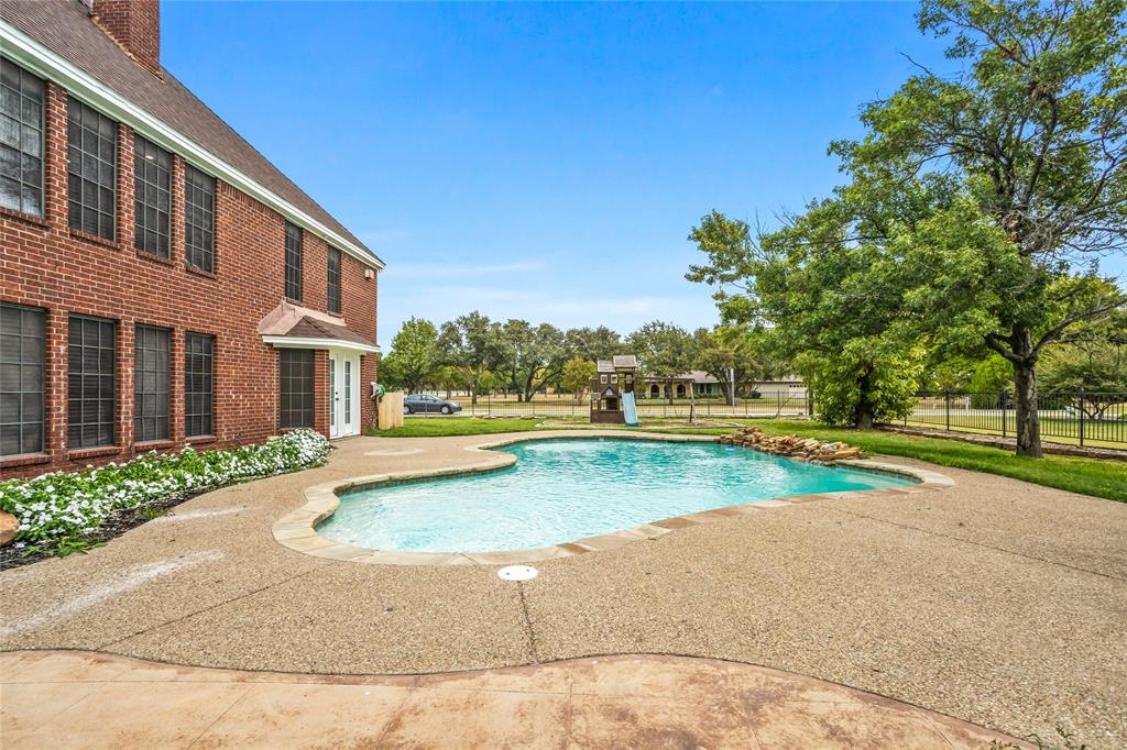 13510 Willow Springs Road Haslet, TX 76052 - Photo 32 of 39 a view of swimming pool and trees in the background