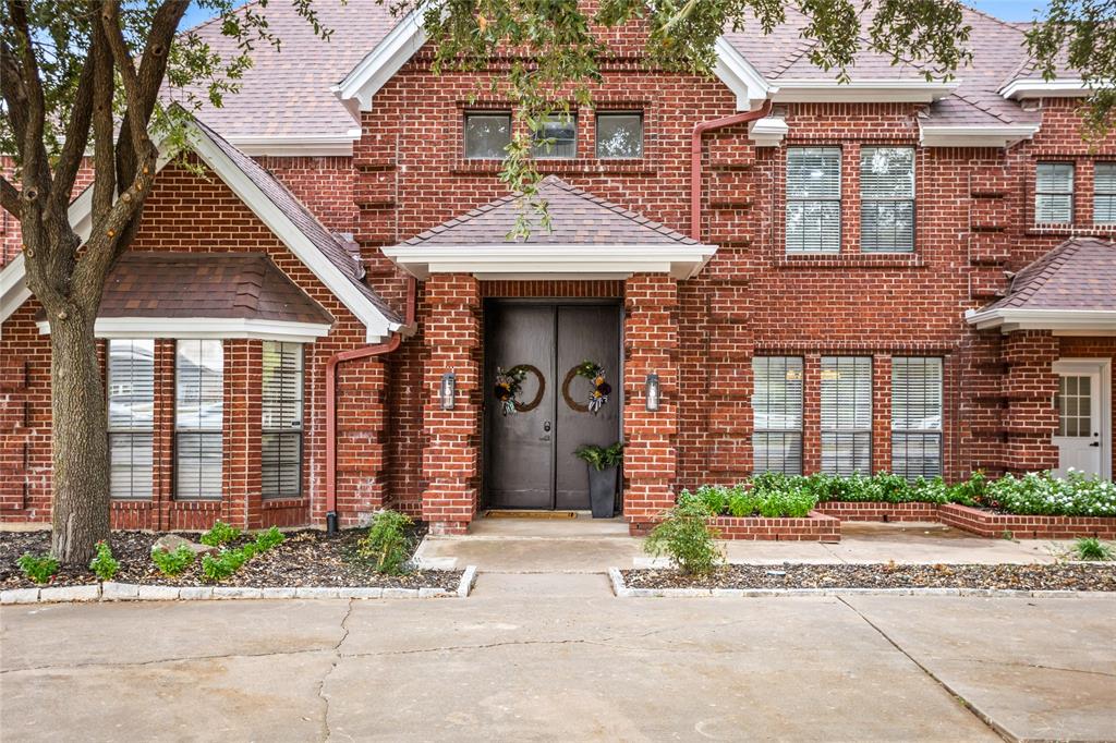 13510 Willow Springs Road Haslet, TX 76052 - Photo 34 of 34 front view of a brick house with a small yard and potted plants