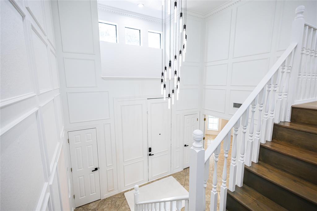 13510 Willow Springs Road Haslet, TX 76052 - Photo 4 of 39 a view of staircase with wooden floor and white walls