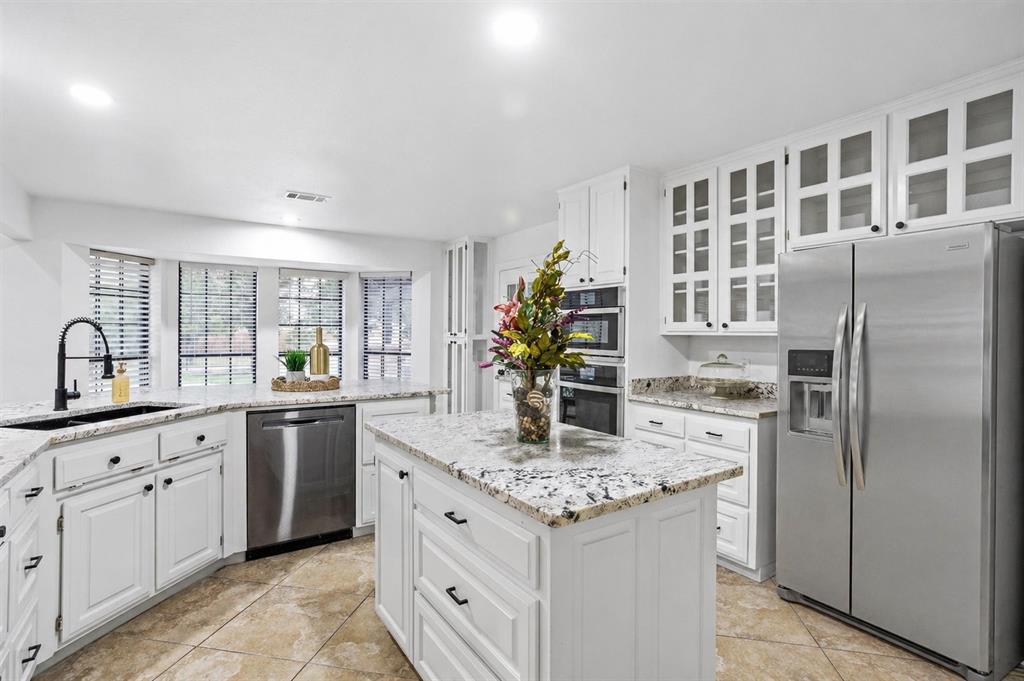 13510 Willow Springs Road Haslet, TX 76052 - Photo 5 of 34 a kitchen with stainless steel appliances granite countertop a sink stove and refrigerator