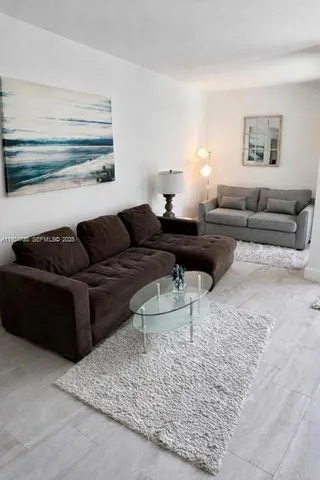a living room with furniture and a rug
