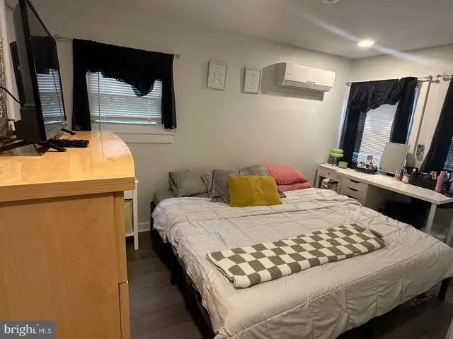 a bedroom with a bed and flat screen tv