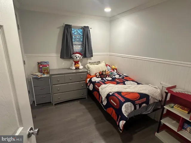 a bedroom with a bed and a baby crib