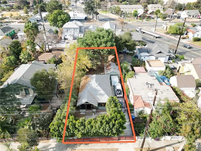 an aerial view of residential houses with outdoor space