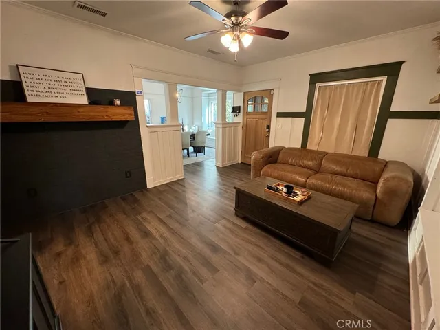 a kitchen with stainless steel appliances granite countertop a refrigerator a stove and a wooden floors