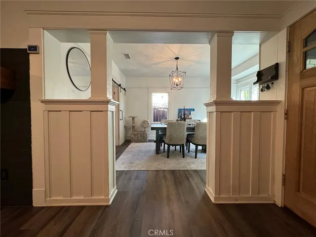 a view of a dining room with furniture wooden floor chandelier