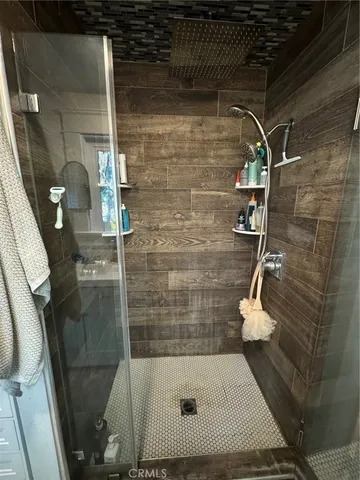 a view of backyard with wooden fence and large trees