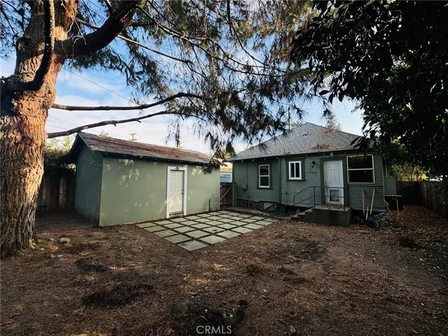 an aerial view of a house with yard and swimming pool