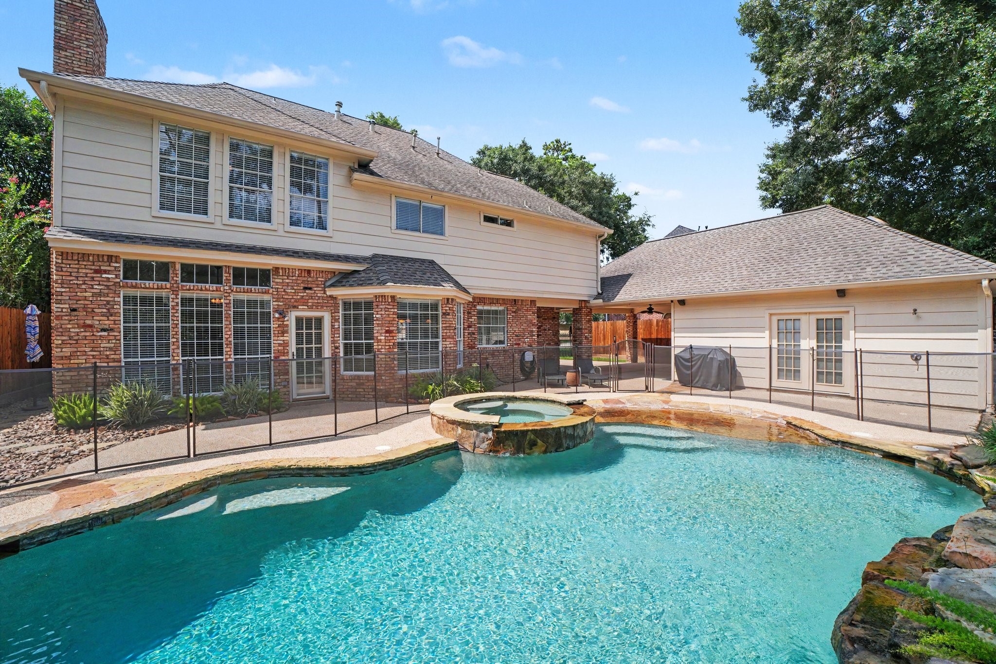 3411 Fir Forest Drive Spring, TX 77388 - Photo 38 of 39 The sparkling saltwater pool features a beach entry, spa, jump rock, and cascading waterfalls, making it the perfect outdoor retreat! The pool also has a chlorinator which allows it to be converted to chlorine, if desired.